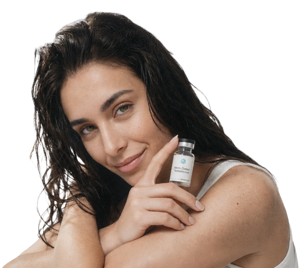 Woman resting her chin on her arms, holding a vial of micro-dosed testosterone